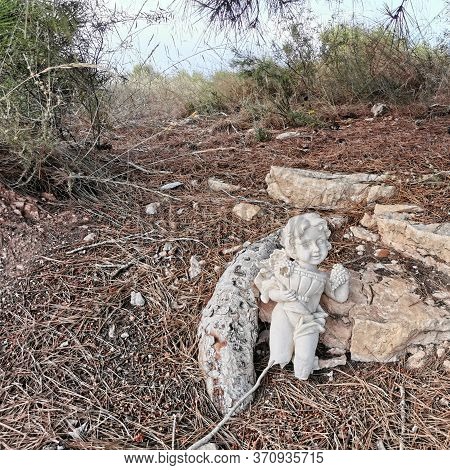 Broken Statue Of An Angel On The Ground