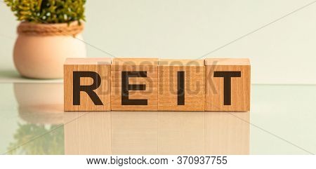 Reit, Real Estate Investment Fund Concept, Cube Wooden Block With Alphabet Building The Word Reit.
