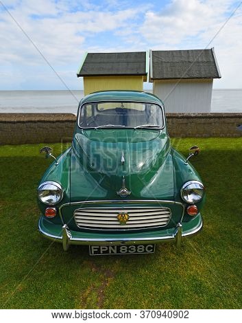 Felixstowe, Suffolk, England - May 05, 2019:  Classic Green Morris Minor With Aa Badge Parked With B