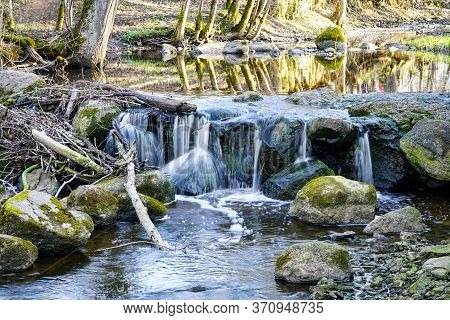 Beautiful View In Spring Of A Waterfall In A Small River