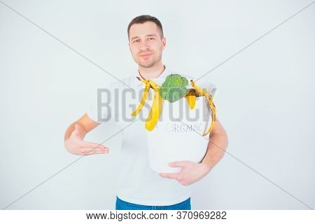 Young Man Isolated Over White Background. Cheerful Positive Guy Hold Bucket With Organic Waste In It