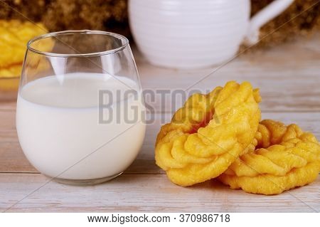 Cruller French Donuts With Glass Of Milk On Wooden Table.
