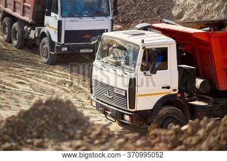 Grodno, Belarus - April 2020: Two Heavy Laden Multi-ton Trucks Maz Exporting Minerals From Open-pit 