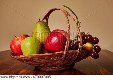 Still Life With Apples, Pear, Banana And Grape Fruit On Wooden Table