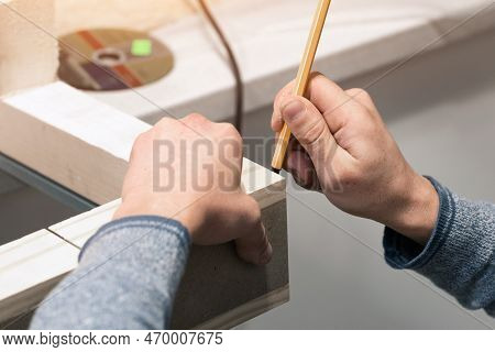 The Carpenter Marks The Dimensions On The Board For Further Cutting, Close-up Of The Carpenters Hand
