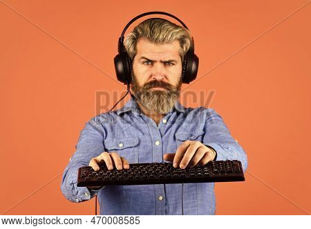 Agile Business. Downloading Music From Internet. Bearded Man Headphones And Keyboard. Professional G