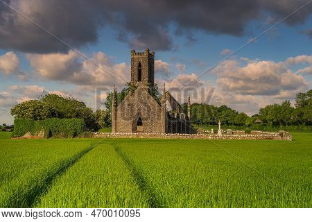 Tracks In Cereal Leading To Old Stone Ruins And Commentary Of Ballinafagh Church With Dramatic Sky A