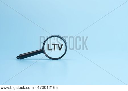 Ltv Text On Magnifier On Blue Background, Business Concept