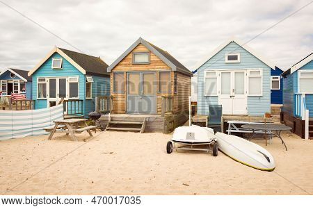 Row Of Wooden Beach Houses On A Sandy Beach. Hengistbury Head, Dorset, Uk