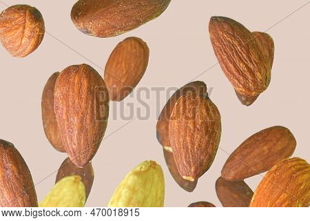 Flying In Air Fresh Raw Whole Almonds Isolated On A Pastel Background. Concept Of Levitating Almonds