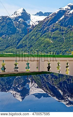 Travel Destination - Reflexion In A Glass Table Of Beautiful Landscape With Mountains Near Hellesylt
