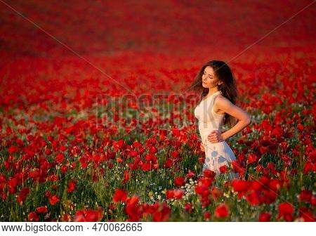 Beautiful And Sexy Brunette Woman Enjoys The Sunshine Of The Setting Sun In The Middle Of A Wonderfu