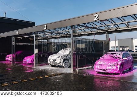 Different Cars On Self Car Wash. Layer Of Foam On The Car. Pink And White Soap. Big Auto Washing