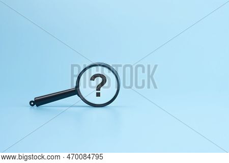Look At The Sign Question Through A Magnifying Glass On A Blue Background