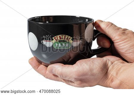 Close Up View Of Man's Hands Holding Big Black Souvenir Cup With Logo Of Central Perk From Famous Se