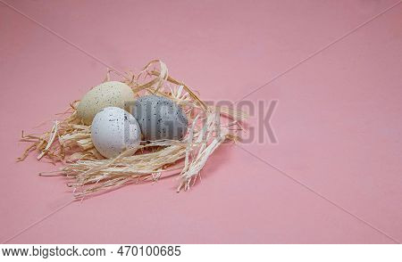 Easter Eggs On Straw Isolated On A Pink Background.