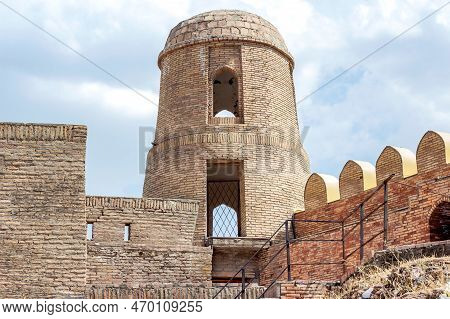 Hisor, Tajikistan - July 31, 2022: Ancient Hisor Fort In Summer Against The Blue Sky.