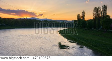 Gorgeous Sunrise On The Waterfront Of River Uzh. Beautiful Urban Scenery Of Uzhhorod Downtown In Spr