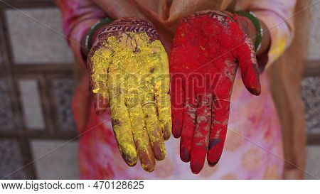 Holi, Festival Of Color, A Woman Girl Lady Wearing Bangles Picking Organic Dry Powder Color Or Colou