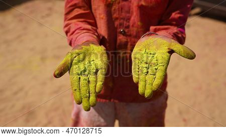 Hands Or Palms Of Young People Covered In Purple, Yellow, Red, Blue Holi Festival Colors Isolated
