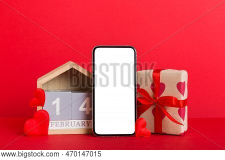 Mobile Phone With Blank Screen On Colored Background With Hearts, Calendar And Gift Box, Valentine D