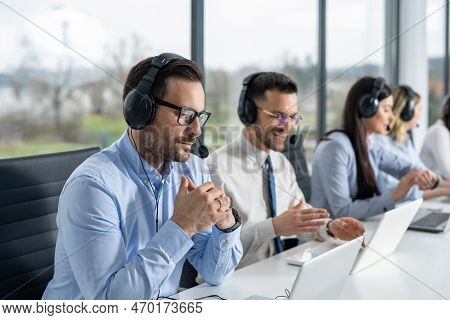 Portrait Of Dedicated Female Operator Agent Working At It Support Sector