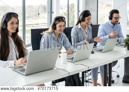 Portrait Of Dedicated Female Operator Agent Working At It Support Sector