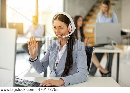 Portrait Of Dedicated Female Operator Agent Working At It Support Sector