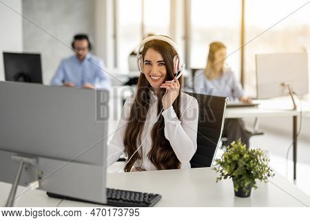 Portrait Of Dedicated Female Operator Agent Working At It Support Sector