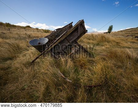 Remains Of Old Historical Traditional Wooden Wheel Cart, Agriculture Farming Tool In High Grass At B