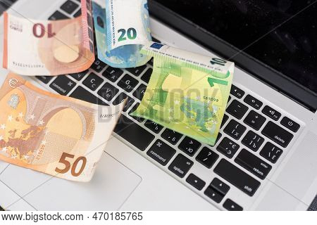Us Hundred Dollar Bills On White Modern Computer Keyboard.