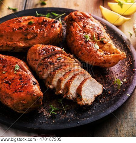Roasted Or Seared Chicken Breast Sliced On A Plate With Herbs And Spices