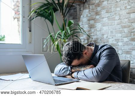 Exhausted Young Caucasian Male Employee Sleep Desk At Office Overwork Preparing Report. Tired Male F