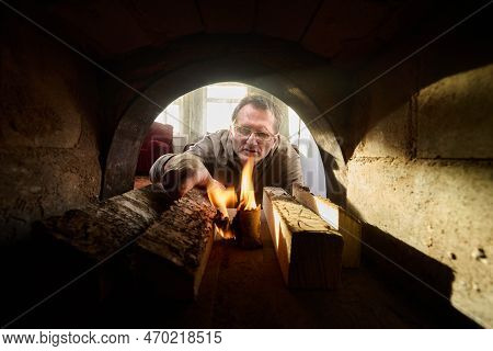 Villager Fired Up Wood Burning Stove Using Birch Bark For Kindling.