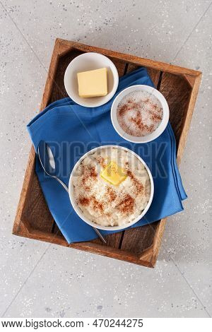 Rice Pudding With Butter Cinnamon. French Riz Au Lait, Norwegian Risgrot, Traditional Breakfast Dess