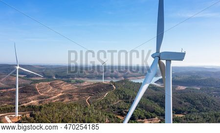 Wind Turbines Generate Clean, Green Electricity In The Fields Of Portugal. With A View Of The Bravur