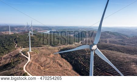 Wind Turbines Generate Clean, Green Electricity In The Fields Of Portugal. With A View Of The Bravur