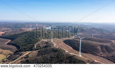 Wind Turbines Generate Clean, Green Electricity In The Fields Of Portugal. With A View Of The Bravur