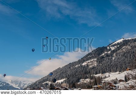 Chateau D'oex, Switzerland - January 29. 2023: Hot Air Balloons Flying. International Hot Air Balloo