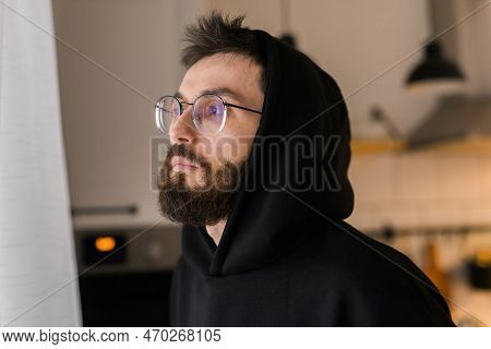 Side View Of Man Longing And Looking Through Window In Sad Day - Depression And Melancholy Concept