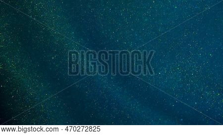 Magical Green Curtain With Golden Sequins. Green Background With Golden Glittering Dust Particles An