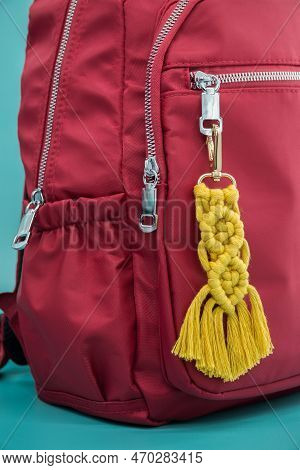 Close-up View Of The Handmade Macrame Key Chain Hanging On The Red Backpack Isolated On The Tiffany 