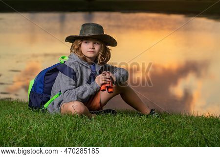 Happy Child Playing With Binoculars. Explore And Adventure. Child Boy With Backpacks Exploring Natur
