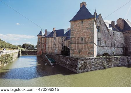 The Ancient Building Of The Chateau In France Around The Lake Building, The Building Close-up Has A 