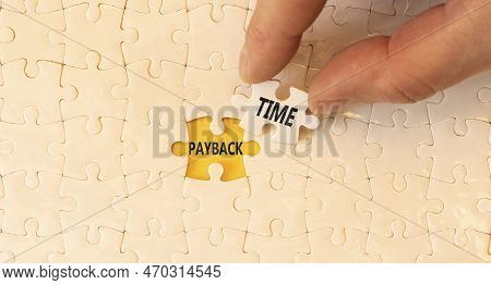 Payback Time Symbol. Concept Words Payback Time On White Paper Puzzles. Beautiful Yellow Table White