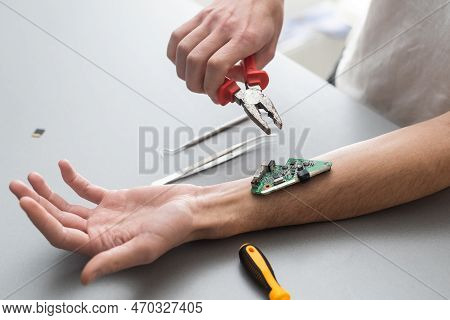 Robot Arm Concept. Man Shows Biomechanical Prosthetic Hand. Guy Repairs His Hand With Tool. Bioengin