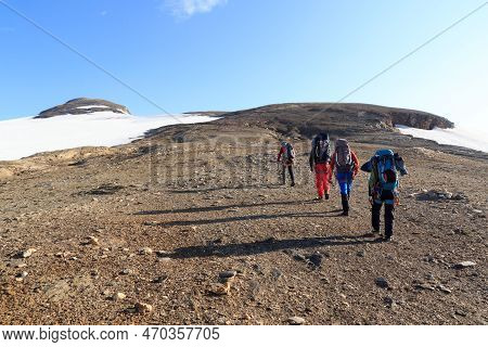 Group Of People Hiking And Mountain Snow Panorama In Glockner Group, Austria