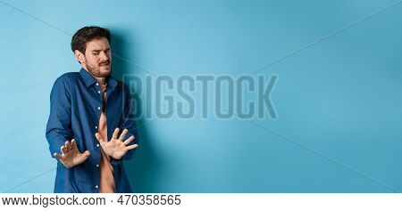 Image Of Man Cringe And Look At Something Disgusting, Step Back From Awful Thing And Block It With H
