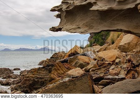 The View Of Rocky Coastline With Blue Sea And An Island On Background, Auckland, New Zealand.