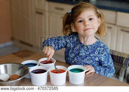 Excited Little Toddler Girl Coloring Eggs For Easter. Cute Happy Child Looking Surprised At Colorful